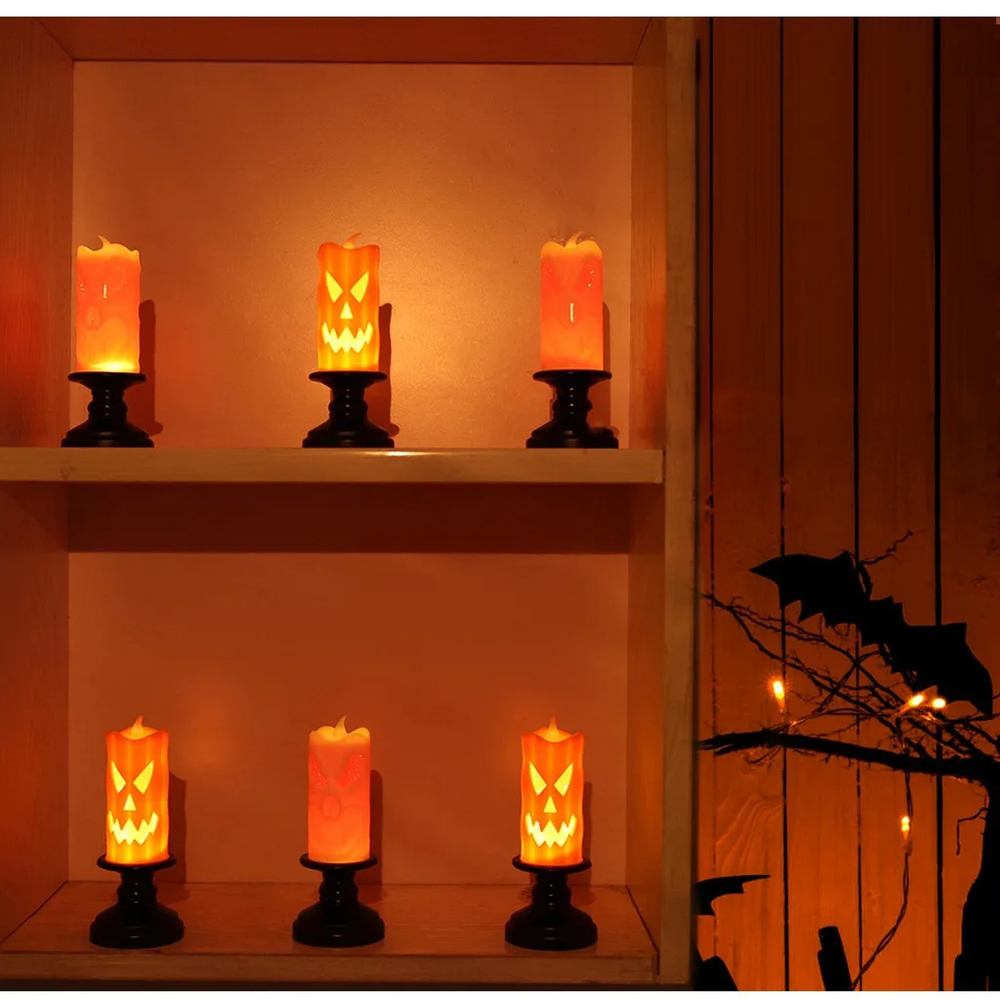 Pumpkin LED Halloween candles lined up on shelves