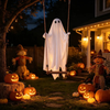 Ghost swing hanging from a tree at night among pumpkins