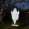 Ghost swing hanging from a branch in a garden