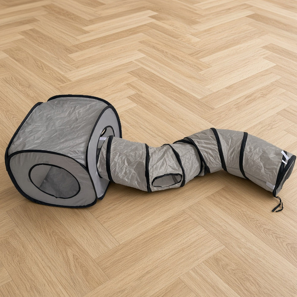 Light grey collapsible cat tunnel on the wooden floor of a living room