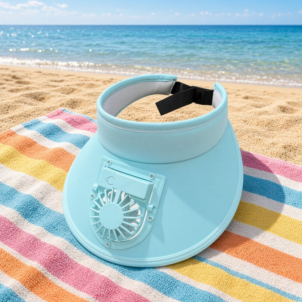 Blue fan sun visor on a striped beach towel facing the sea