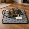 Cat asleep on the grey paw print heated pet mat, EU plug