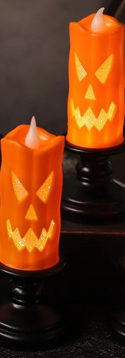 Orange LED Halloween candles on black candlesticks
